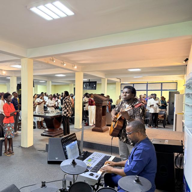 The band leading worship as the congregation stands